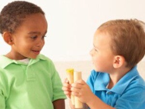 Baby boys playing with wooden toys