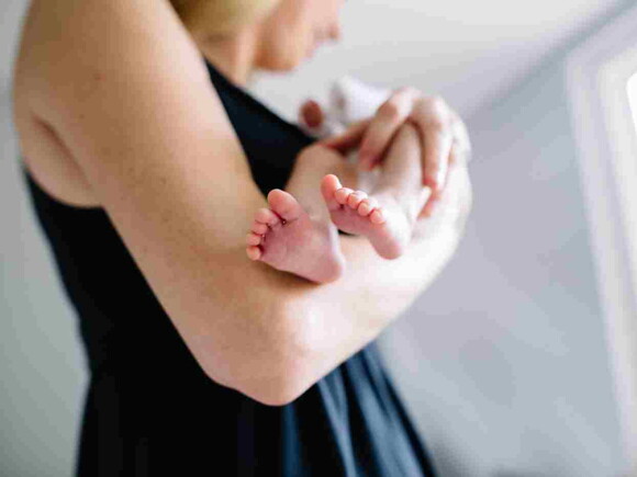 Une femme tient son bébé qui a des régurgitations – Nestlé Baby&Me