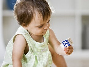 Baby girl playing with cubes