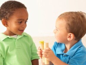 Baby boys playing with wooden toys