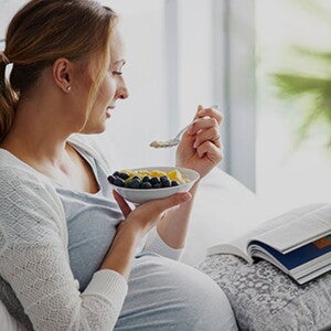 article-finder-teaser Pregnant woman having fruits while reading