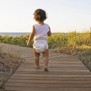 Baby walking to the beach