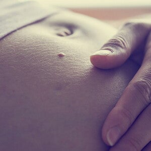 Pregnant touching her belly