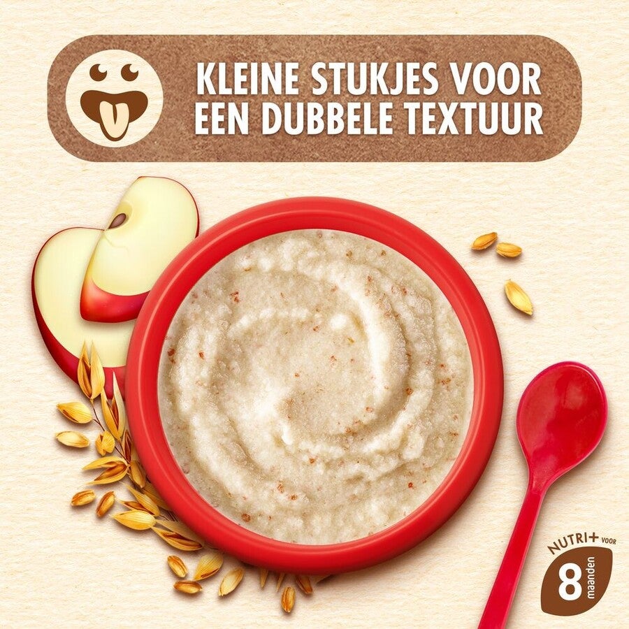Rood kom havermout met appelstukjes en rode lepel, omgeven door graankorrels.