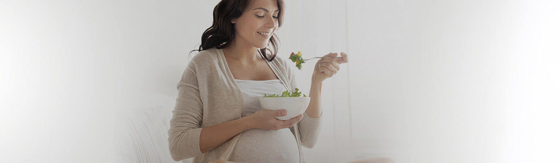 Pregnant woman eating salad Pregnant woman eating salad