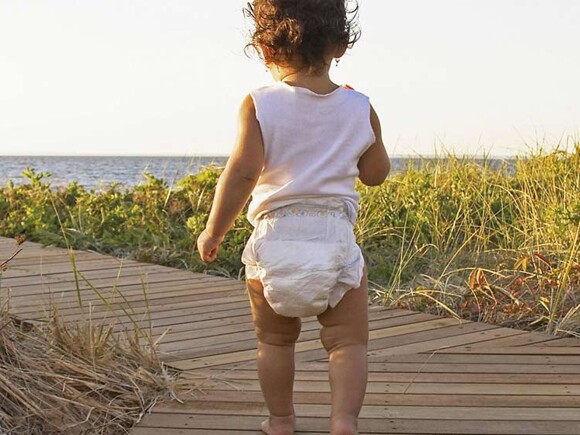 Baby walking to the beach