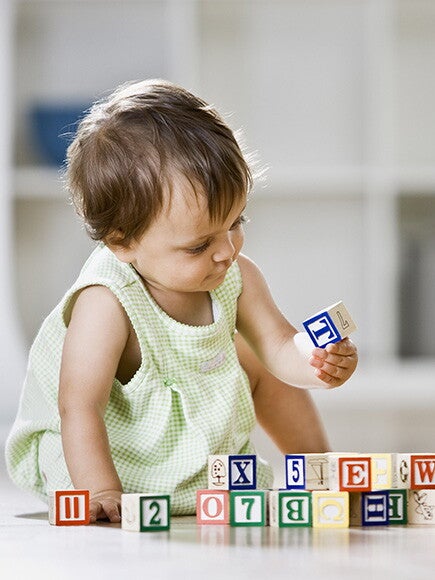 Baby girl playing with cubes